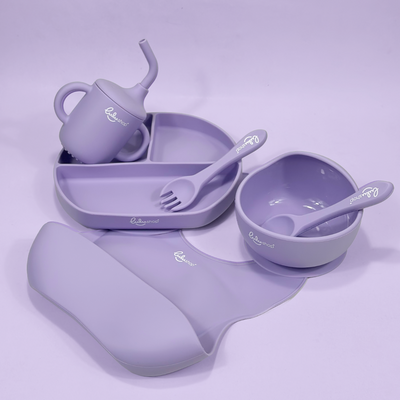 Lulushop 6-piece baby feeding set in Lavander Mist, featuring silicone suction plate, bowl, bib, cup, and utensils.