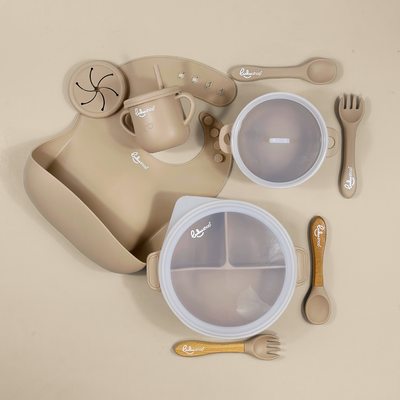 Lulushop 9-piece baby feeding set in Light Apricot, featuring silicone suction plate, bowl, bib, cup, and utensils.